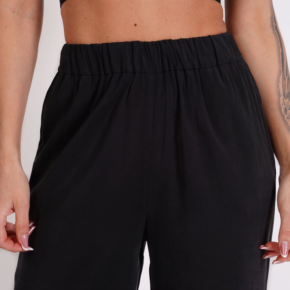 
                  
                    Straight-fit trousers with elasticated waistband
                  
                